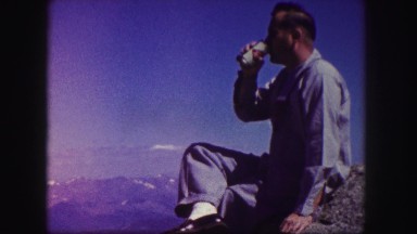 1958: man talking to another person while enjoying nature and sitting outside