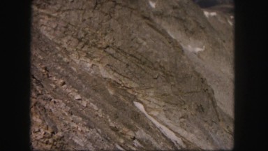 1958: a rugged mountain top with crevices filled with snow COLORADO