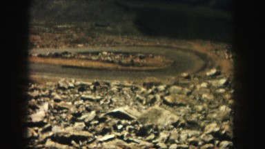1958: A Vehicle Coming Slowly Through a Serpentine Road in Stony Land