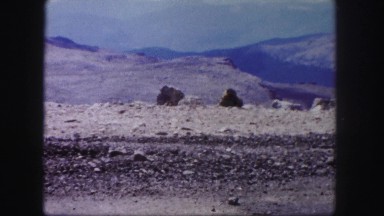 1958: dry rocky terrain car drives up barren road landscape COLORADO
