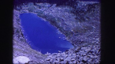 1958: blue sparkling lake with water like a diamond in the valley COLORADO