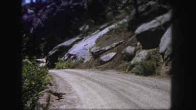 1958: a dirt road winding and cutting through a mountain top COLORADO