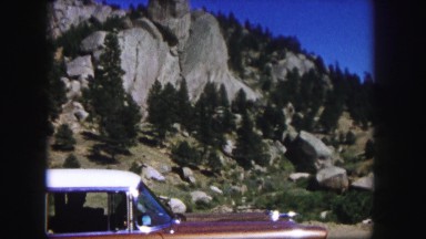 1958: a beautiful blue sky above a beautiful rugged mountain peak as seen pine