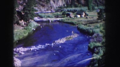 1958: mountain river running below bridge above view COLORADO