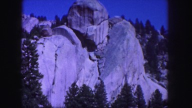 1958: a rock face reminiscent of mount rushmore eerie and foreboding towering