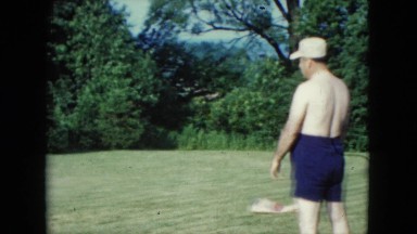 1957: a father and son playing catch in the yard and a dog trying to get in