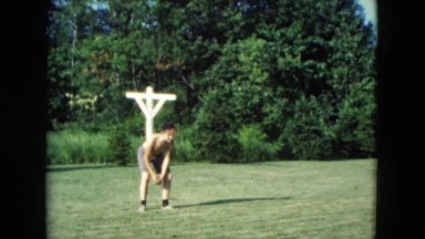 1957: two bare chested males throw white ball to each other
