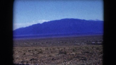 1957: vast barren land fringed by blue mountains in the distant DEATH VALLEY