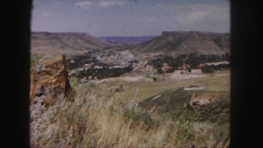 1958: scenic clip of view of field and village near a mountain COLORADO
