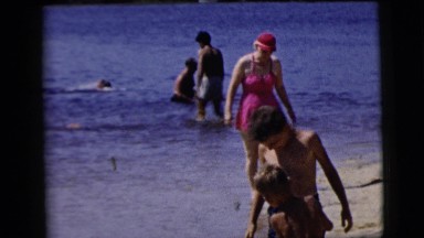 1958: various people walking in the sand and surf on the beach NEW YORK CITY