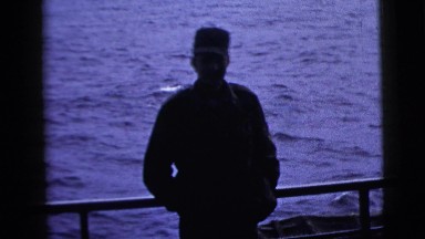 1958: man people watching while situated against the side of a boat NEW YORK