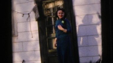 1958: Woman Descends Steps Outside Home, Lifts Skirt Hem Above Knee