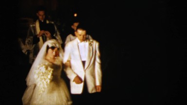 1958: man and woman tie the knot, dressed to the nines with happy guests