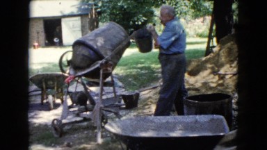 1960: Men Working with Wheelbarrows and Cement Mixer in Wauconda, Illinois