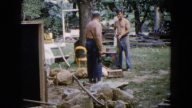 1960: two men working outside with rocks and sledgehammers WAUCONDA, ILLINOIS
