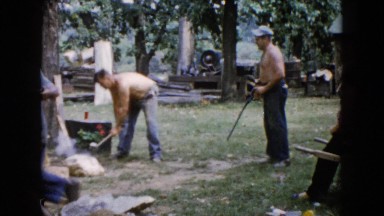1960: man pretends to shoot rifle at laborer
