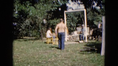 1960: spending time in the backyard with family and friend on swinging bench.