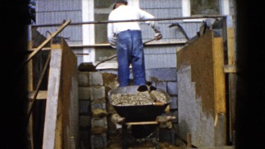 Man Working with Wheelbarrow and Cement