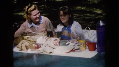 1960: two women outside at a table enjoying a picnic WAUCONDA, ILLINOIS
