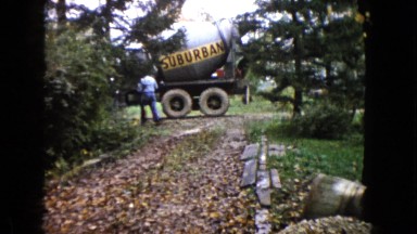 1960: girl walks in front of cement truck in the distance WAUCONDA, ILLINOIS