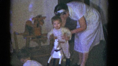 1959: kids in pajamas opening gifts from under a christmas tree CATSKILL GAME