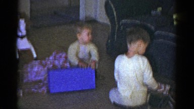1959: children in pajamas opening their christmas gifts on the floor CATSKILL