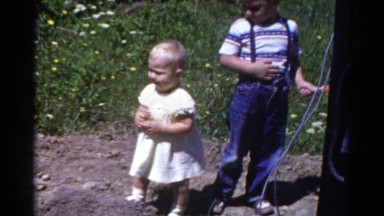 1959: two adorable children standing outside in a dirt patch CATSKILL GAME FARM