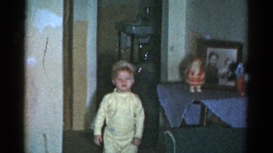 1959: kids in pajamas opening gifts from under a christmas tree CATSKILL GAME