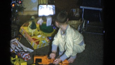 1959: a christmas tree is seen with a child opening presents CATSKILL GAME FARM