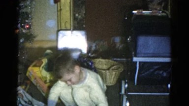 1959: a christmas tree is seen with a child opening presents CATSKILL GAME FARM