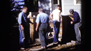 1960: five men at work doing construction work and discussing about the work