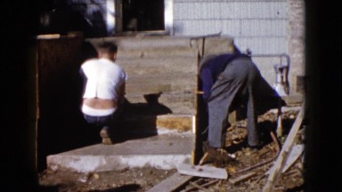 1960: Men Working With a Large Trowel and Cement on a Walkway