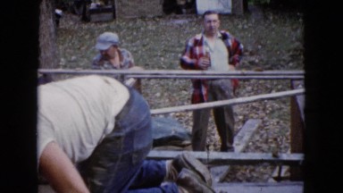 1960: dude oversees a project being done by his employees and enjoys a cold beer