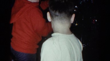 1959: a christmas tree is seen with a child opening presents CATSKILL GAME FARM