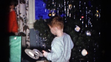 1959: a christmas tree is seen with a child opening presents CATSKILL GAME FARM