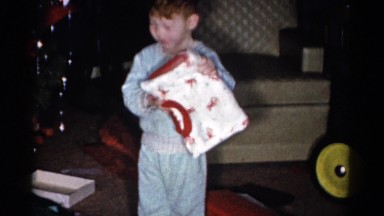 1959: a christmas tree is seen with a child opening presents CATSKILL GAME FARM