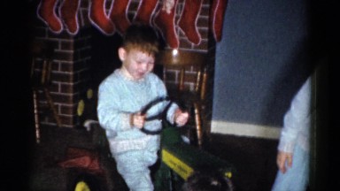 1959: kids in pajamas playing around a boy riding a tractor CATSKILL GAME FARM