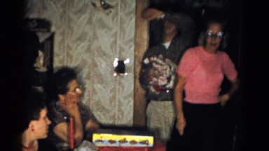 1959: lady in pink looking around room full of people CATSKILL GAME FARM