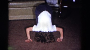 1959: little girl shows off her summersault skills to the family