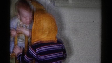 1959: child wearing a mask and scaring a baby CATSKILL GAME FARM, NEW YORK