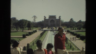 1974: children outdoors observing a historic structure with a fountain INDIA