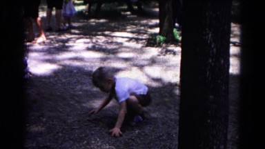 1963: sweeping boy in white shirt on the ground with his hands COLD SPRINGS