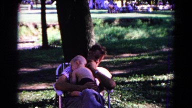 1963: a father with child is seen near a tree COLD SPRINGS, NEW YORK