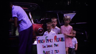 1963: children outside holding up a large family reunion sign COLD SPRINGS, NEW