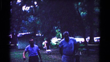 1963: various adults and children strolling through the woods in a park