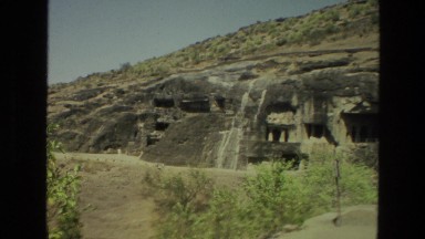 1974: cave dwellings carved into the side of a rocky mountain INDIA