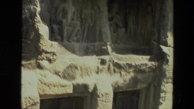 1974: two people standing at old structure made in stone or mountain INDIA
