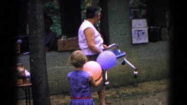 1963: a women outside at a picnic carrying a child's seat COLD SPRINGS, NEW YORK