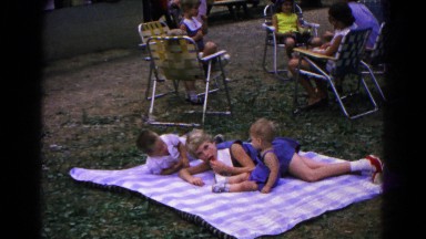 1963: kids gather around blowing balloons at a family picnic COLD SPRINGS