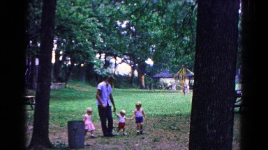 1963: a father with child is seen near a tree COLD SPRINGS, NEW YORK